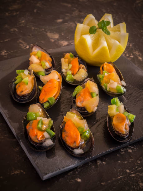 istock Vinaigrette mussels served on a black stone plate 916841652