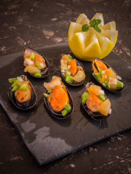 istock Vinaigrette mussels served on a black stone plate 916841660