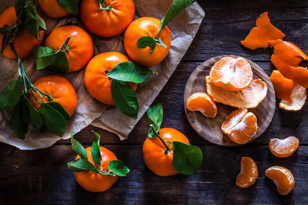 istock Fresh organic mandarins on rustic wooden table 916844146