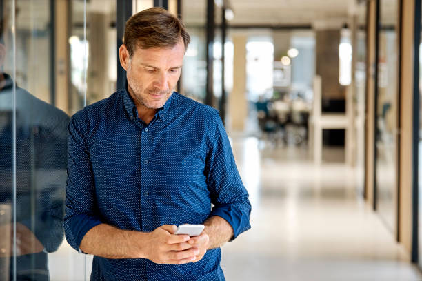 istock Mature businessman using mobile phone in office 916844244