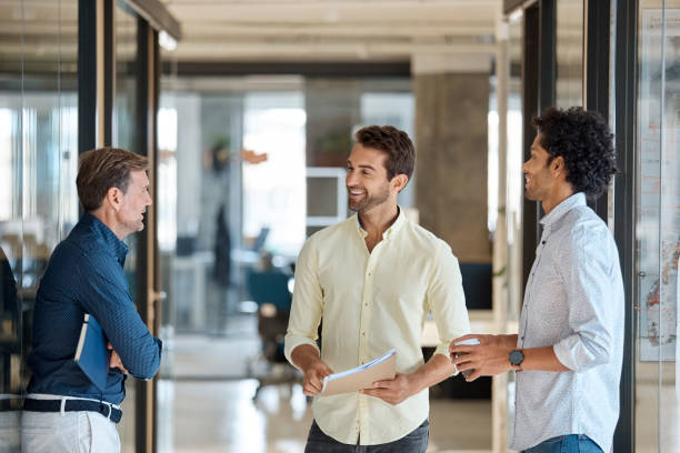 istock Businessman discussing with colleagues in office 916844360