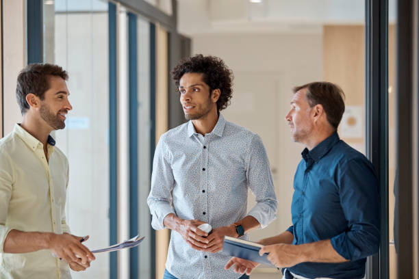 istock Businessman discussing with colleagues in office 916844380