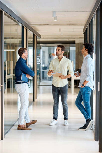istock Businessman discussing with colleagues in office 916844412