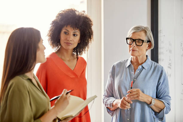 istock Multi-ethnic businesswomen discussing in office 916844626
