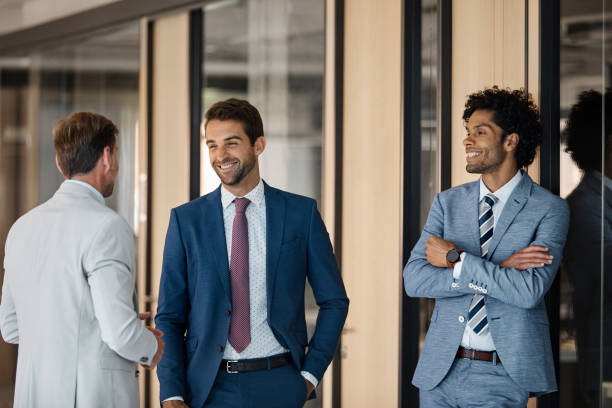 istock Smiling businessman with colleagues in office 916849056