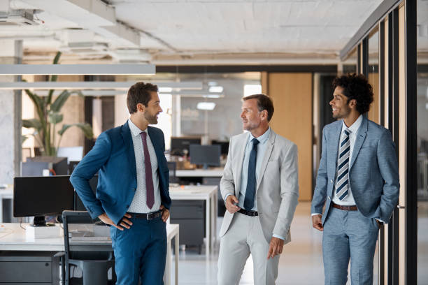 istock Businessman discussing with colleagues in office 916849130