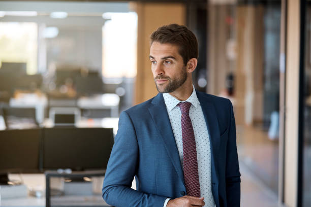 istock Confident businessman looking away in office 916849170