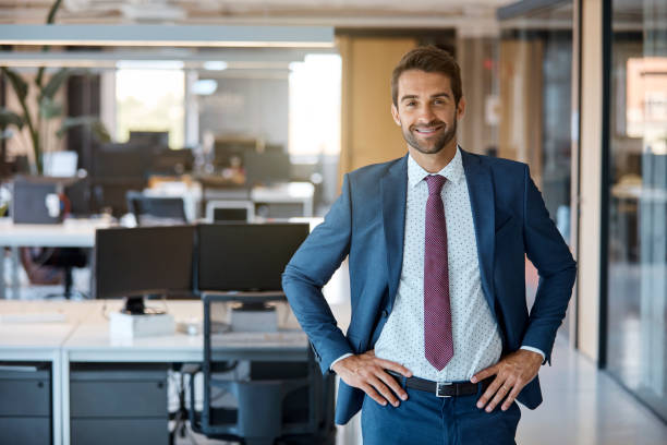 istock Businessman standing with hands on waist in office 916849182