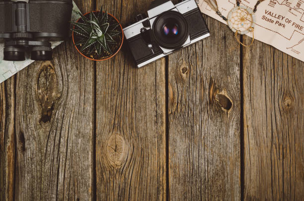 Travel accessories top view on wooden background with copy space