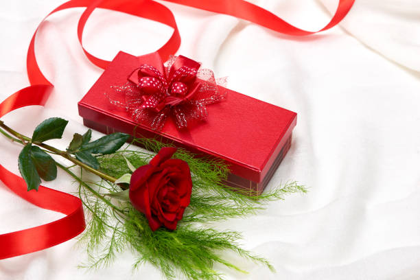 istock Valentine day background with red gift boxes with red rose on white background. 916852162
