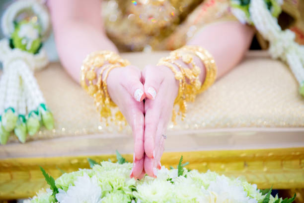 istock Hands pouring blessing water into bride's bands 916855378