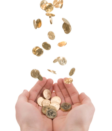 Gold US dollar coins fall from the top of the frame into outstretched cupped hands at the bottom. Isolated on white .