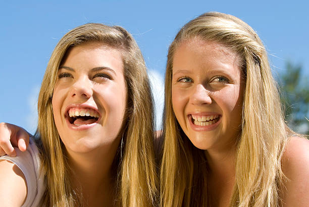 Best friends Two teenage girlfriends laughing teenager couple child blond hair stock pictures, royalty-free photos & images