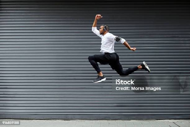 Sporty Young Man Jumping Against Shutter Stock Photo - Download Image Now - Jumping, People, Men