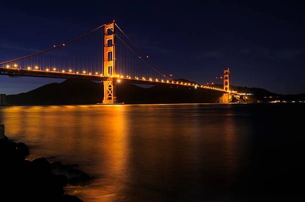 Glowing Golden Gate Bridge and star trails stock photo