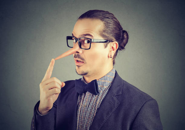 istock Liar businessman with long nose 916863382