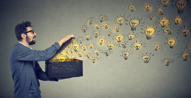 Side view of a man holding box with brilliant ideas being creative