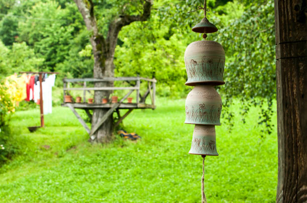 istock Countryhouse garden view with clay wind bells 916866676