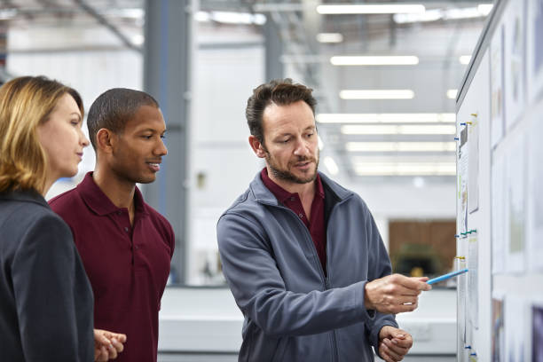 istock Engineer showing chart to colleagues in meeting 916867318