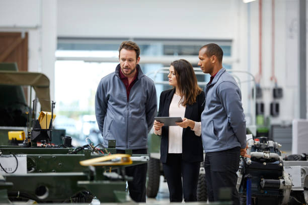 istock Automobile workers discussing in factory 916867422