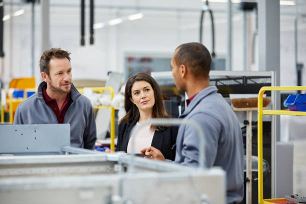 istock Engineers and manager discussing in car factory 916867484