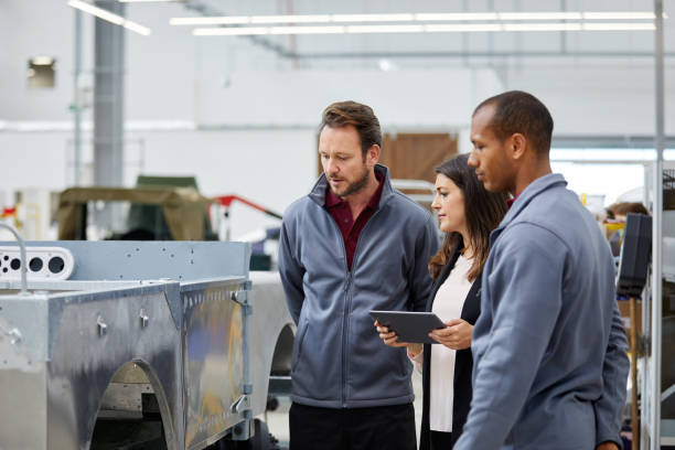 istock Engineers and supervisor examining metal car frame 916867510