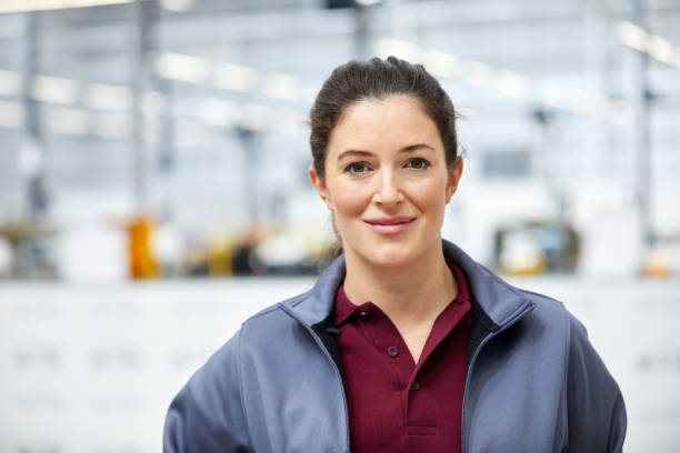 istock Female engineer smiling in car plant 916867968