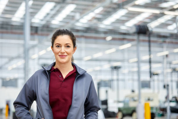 istock Smiling female engineer in automobile industry 916868012