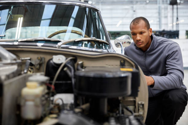 istock Young male engineer examining car in industry 916868026
