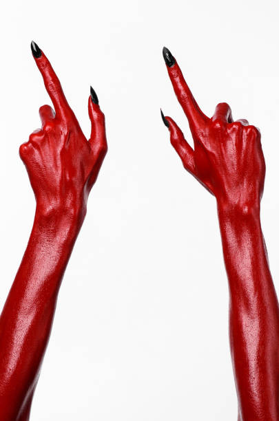 istock Red Devil's hands, red hands of Satan, Halloween theme, white background, isolated 916868072