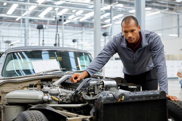 istock Male engineer examining car engine in industry 916868082