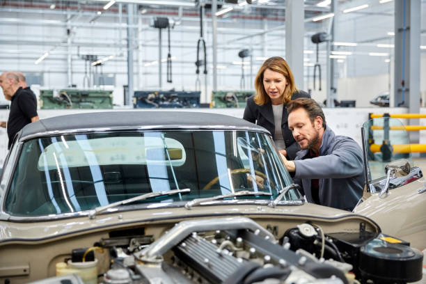 istock Engineer and supervisor examining vintage car 916868296
