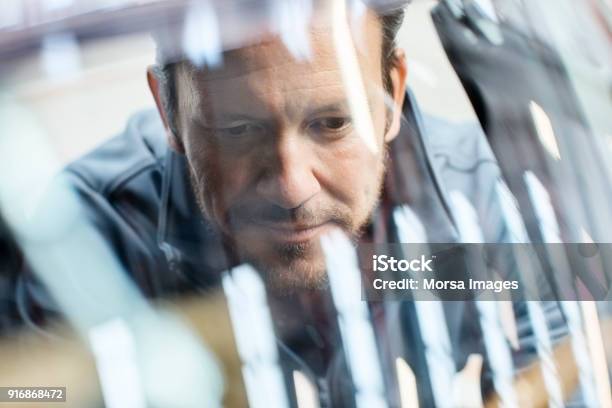 Engineer Seen Through Car Windshield In Industry Stock Photo - Download Image Now - Car, Engineer, Industry