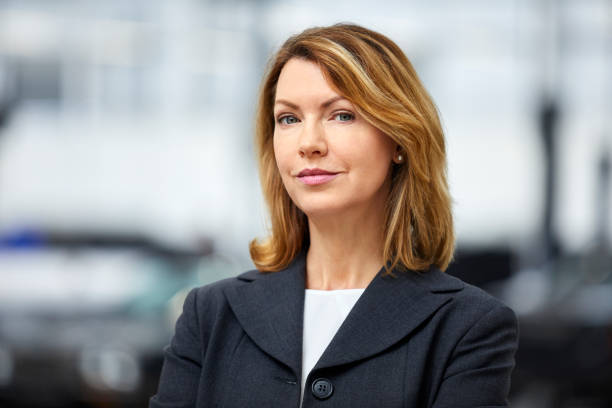 istock Female engineer with blond hair in car plant 916868892