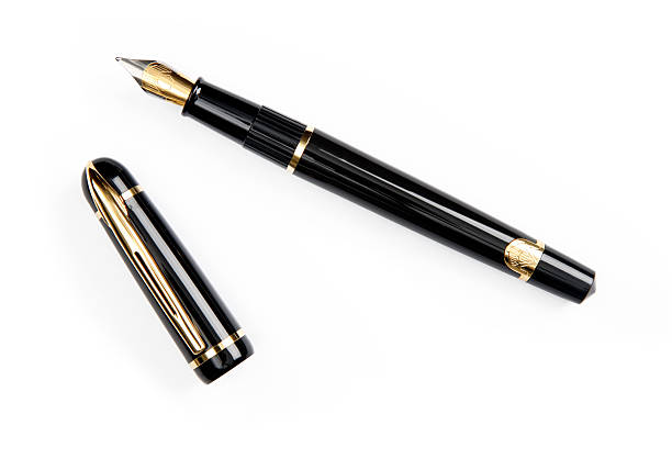A gold-nibbed fountain pen on a white background