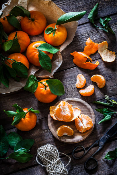 istock Fresh organic mandarins on rustic wooden table 916873498