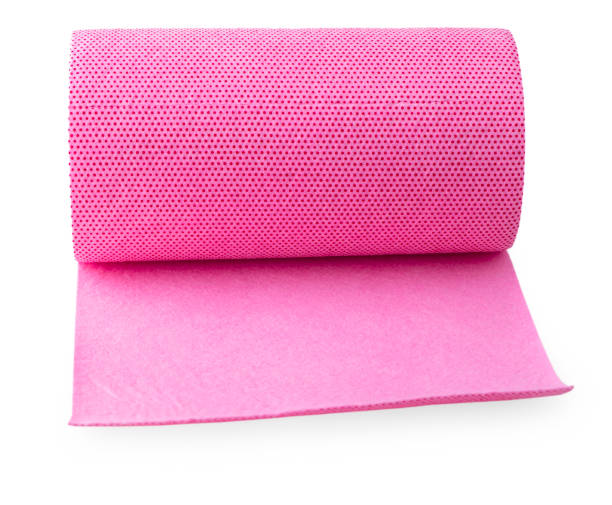 istock roll of pink colored wrapping foil isolated on white background. 916873704