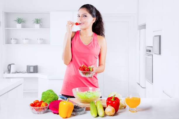 istock Beautiful Indian Woman tasting strawberry 916874276