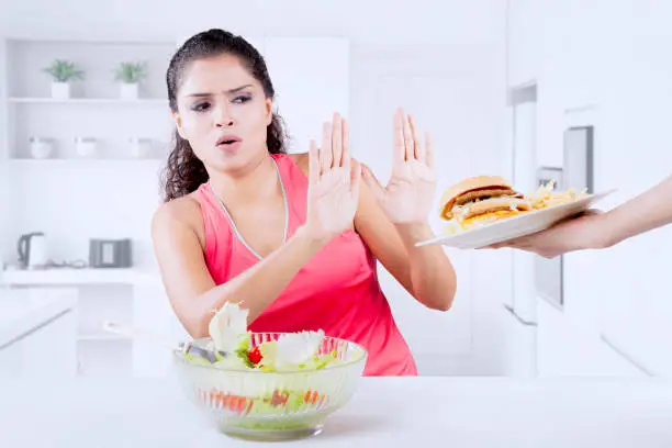 Indian woman refusing junk food and prefer healthy food