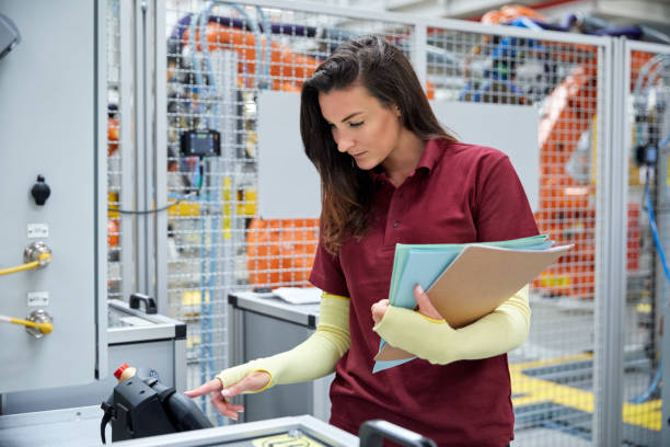 istock Inspector operating machinery in car industry 916875176