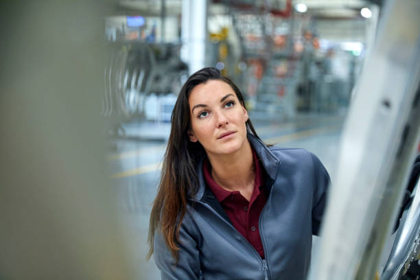 istock Engineer examining car chassis in industry 916875378