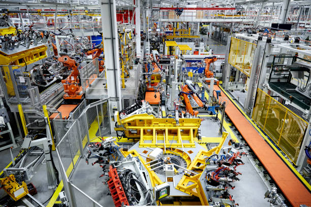 istock Robotic arms in a car manufacturing factory 916875596