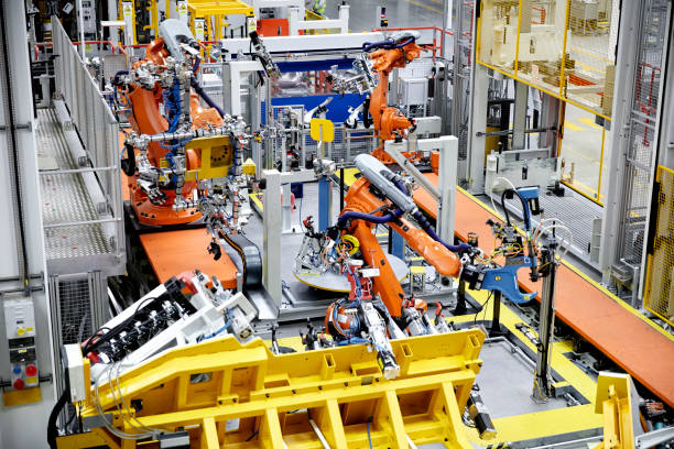istock Robotic arms in a car manufacturing factory 916875604
