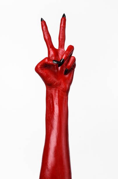 istock Red Devil's hands, red hands of Satan, Halloween theme, white background, isolated 916880688