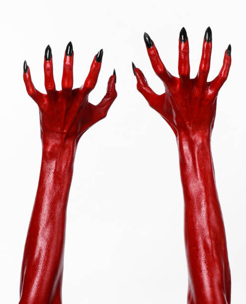 istock Red Devil's hands, red hands of Satan, Halloween theme, white background, isolated 916881854
