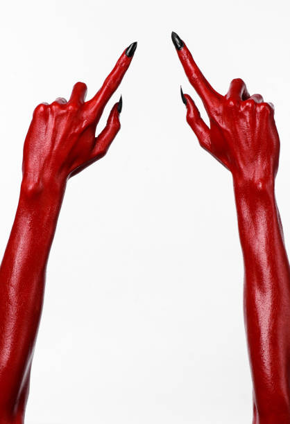 istock Red Devil's hands, red hands of Satan, Halloween theme, white background, isolated 916884400