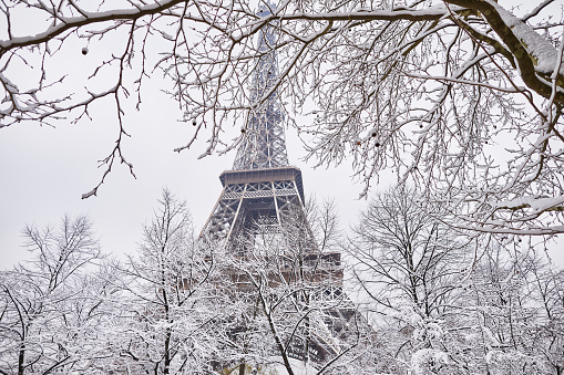 Scenic view to the Eiffel tower on a day with heavy snow. Unusual weather conditions in Paris