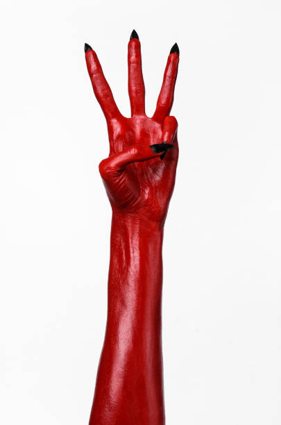 istock Red Devil's hands, red hands of Satan, Halloween theme, white background, isolated 916885048