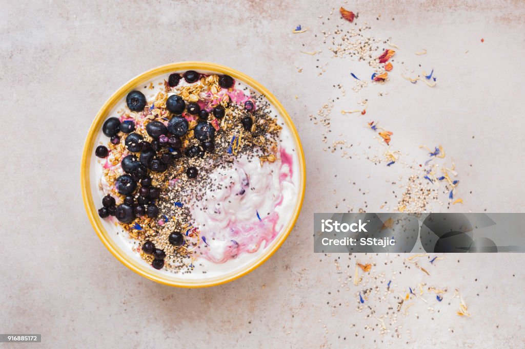 Coconut blueberry breakfast bowl with chia and sesame seeds Coconut blueberry breakfast bowl with chia and sesame seeds on concrete. Top view, blank space Bowl Stock Photo