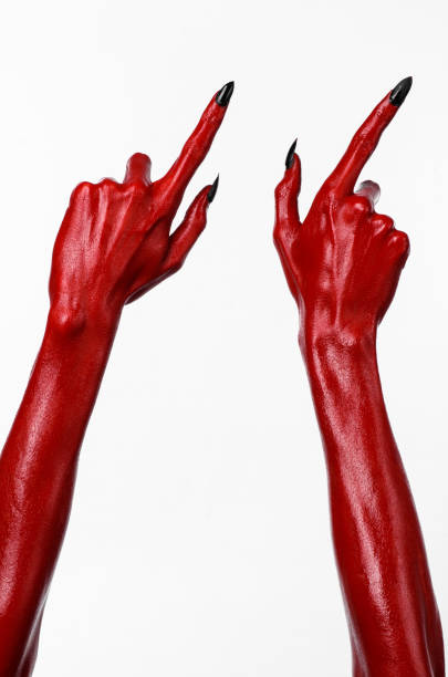 istock Red Devil's hands, red hands of Satan, Halloween theme, white background, isolated 916885316